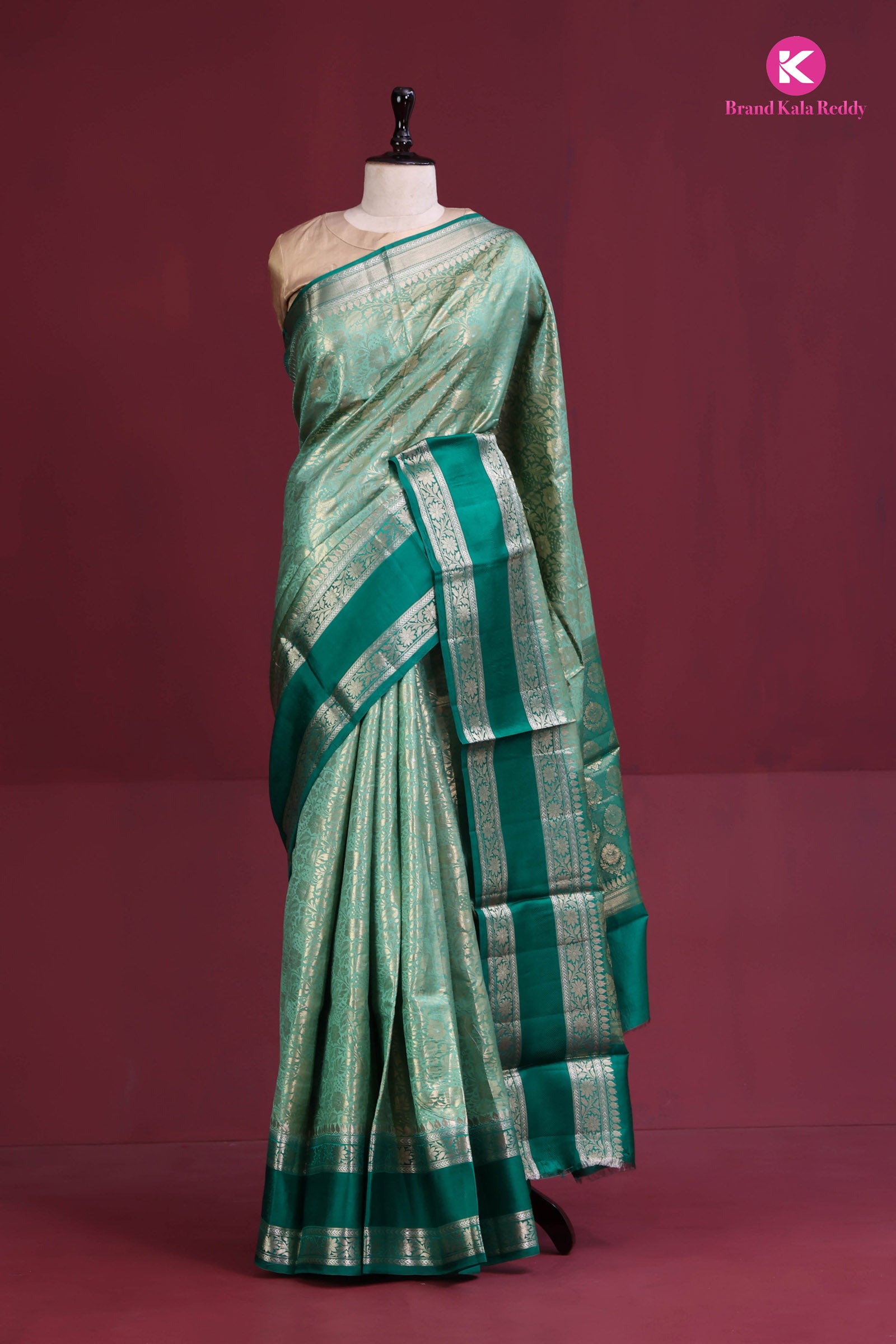 The deep bottle green saree