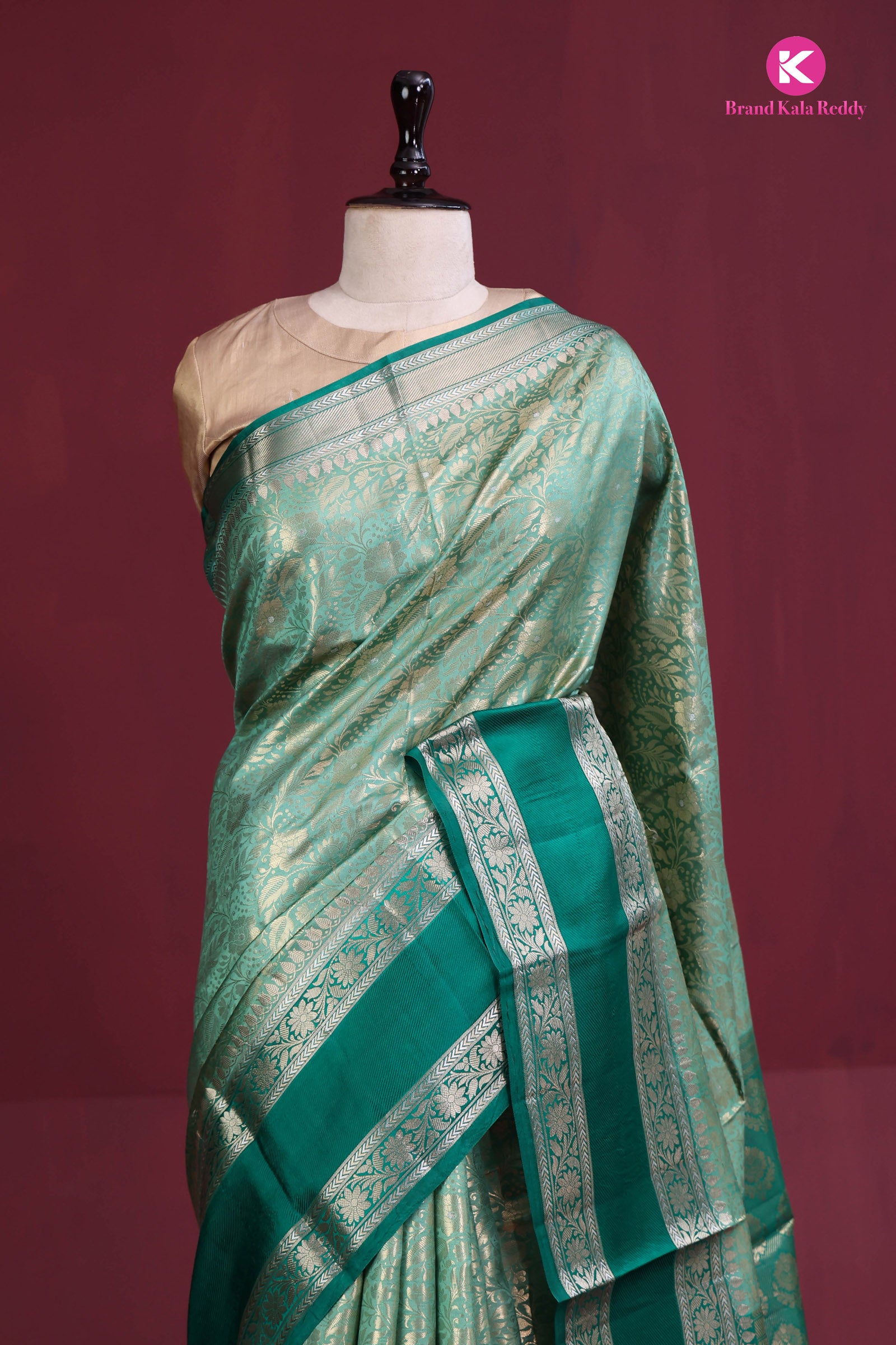 The deep bottle green saree