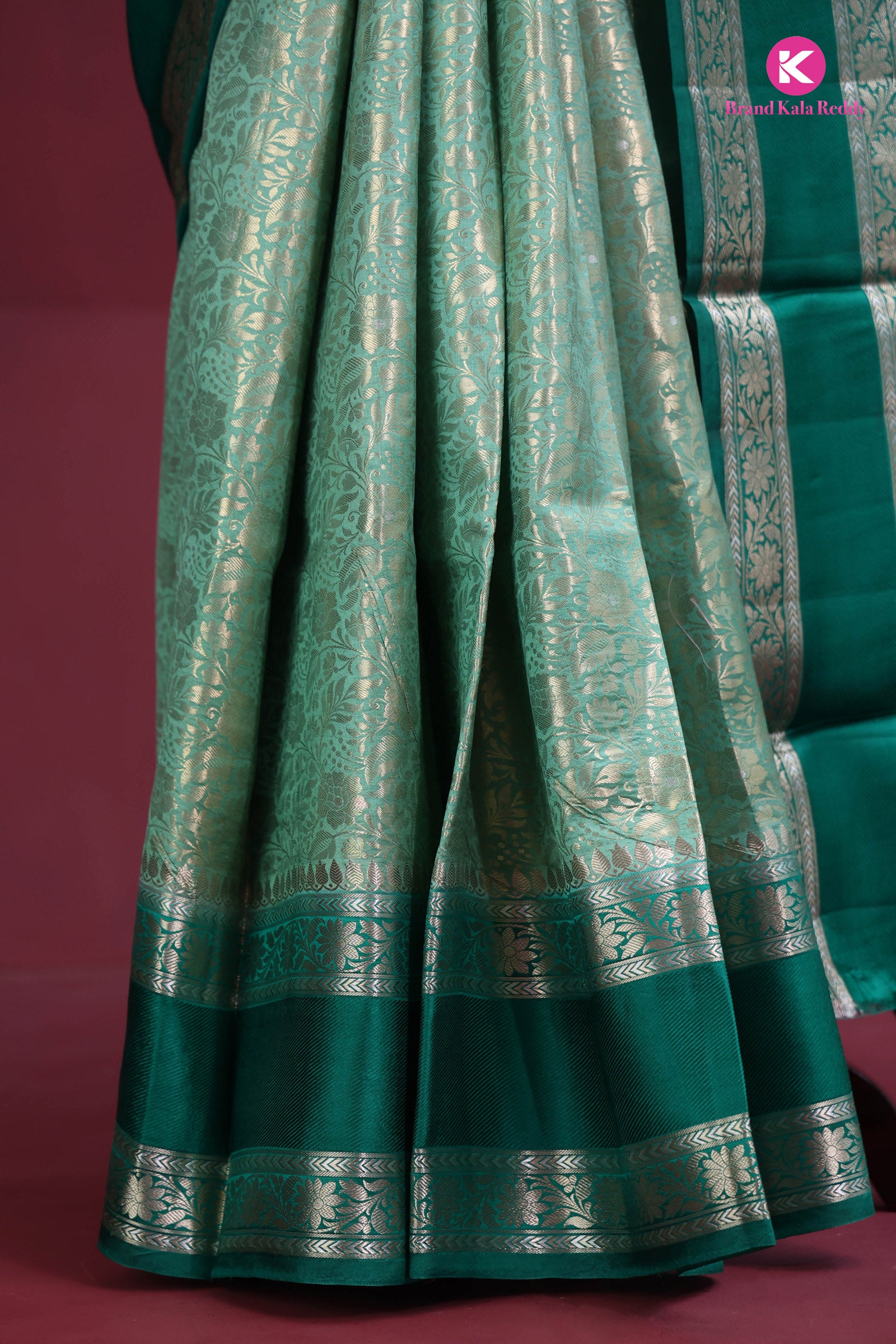 The deep bottle green saree