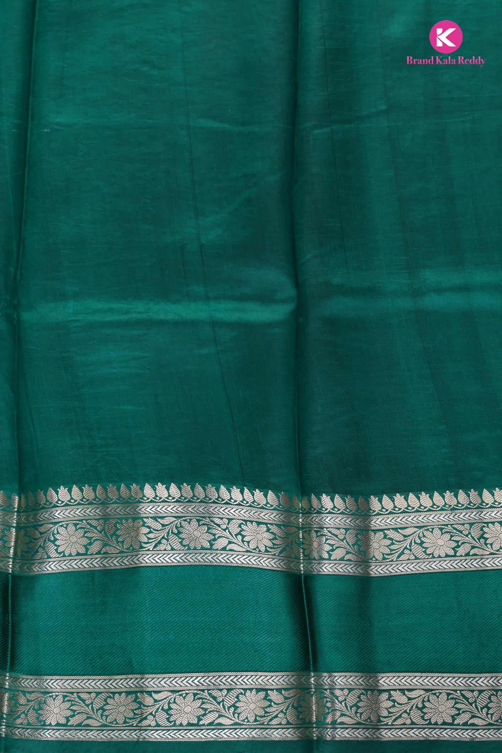 The deep bottle green saree